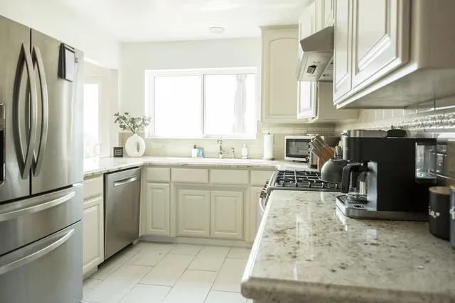 a kitchen with refrigerator and window
