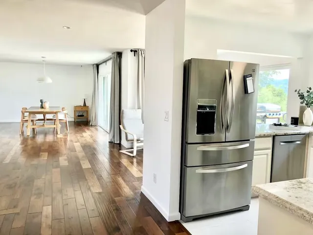 a kitchen with kitchen island a counter top space and stainless steel appliances