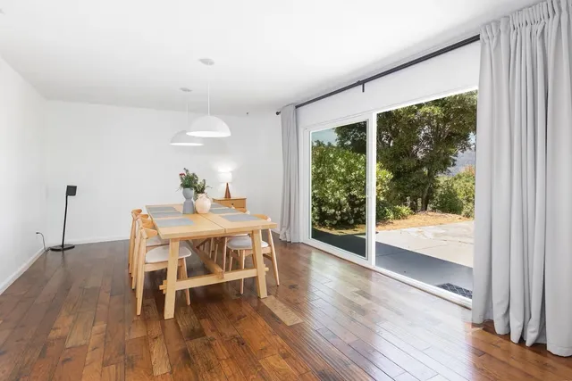 a dining room with furniture and wooden floor
