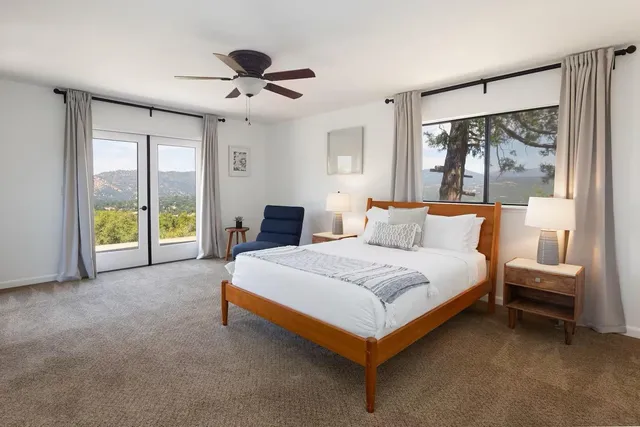 a spacious bedroom with a bed and a large window