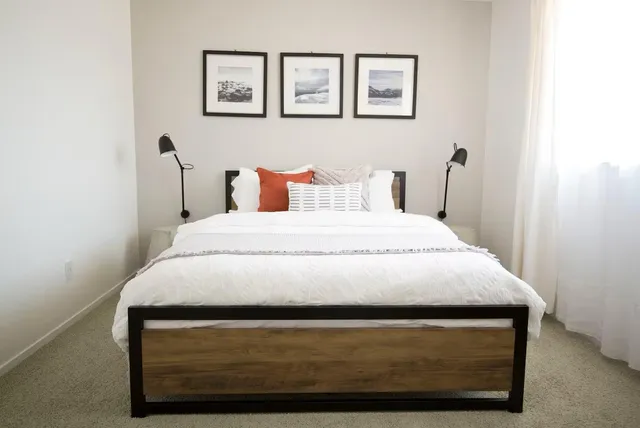 a bedroom with a bed and two night stand