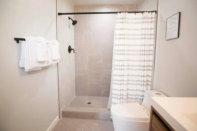 a bathroom with a shower curtain and a sink