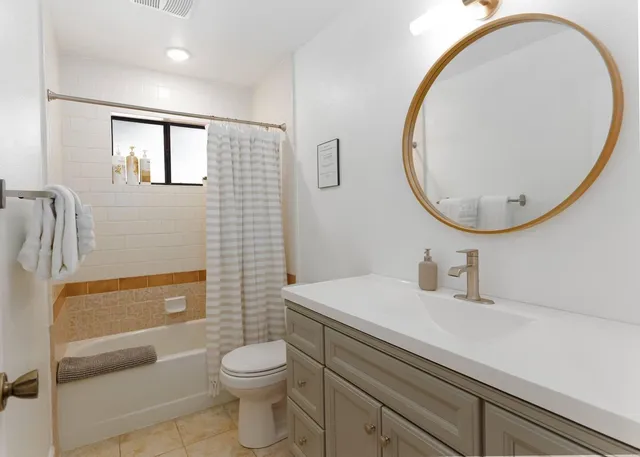 a bathroom with a sink a toilet and a mirror