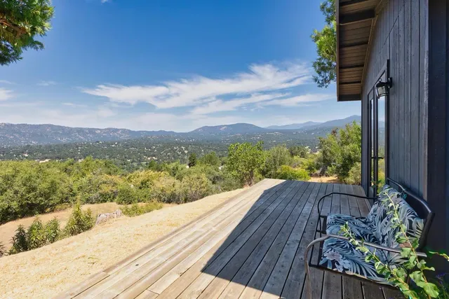 a view of a balcony with wooden floor and outdoor space