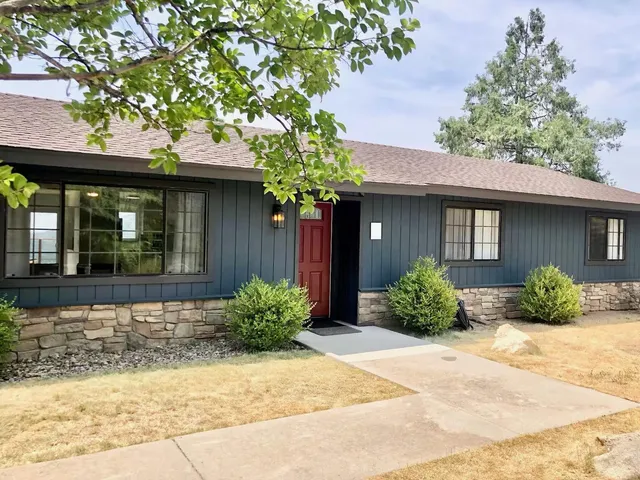 a front view of a house with garden