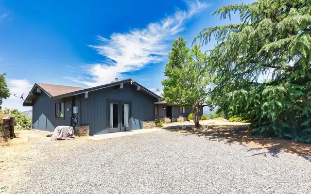 a view of a house with a yard covered in snow
