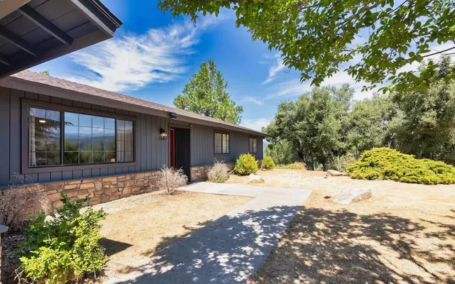 a front view of a house with a yard and chandelier