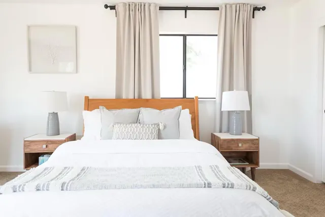 a bedroom with a bed and a window