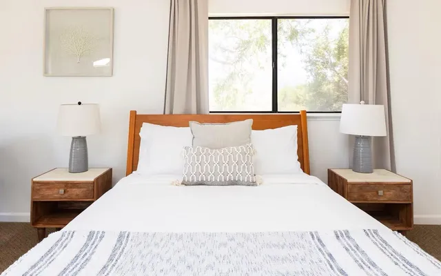 a bedroom with a bed and a window