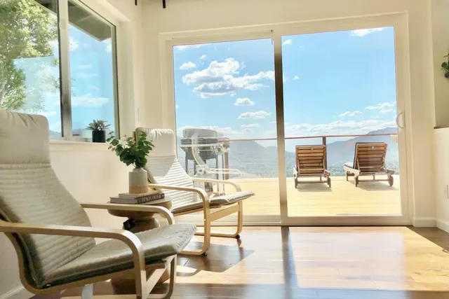 a view of a dining room with furniture next to a window