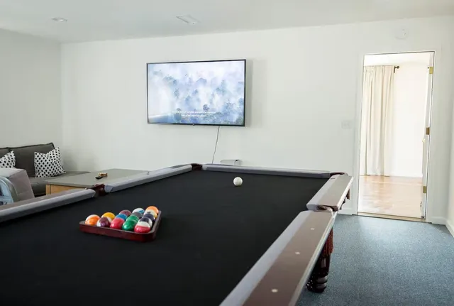 a black leather couch sitting in a living room with a couch