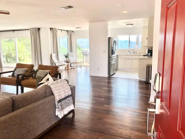 a living room with furniture and large windows