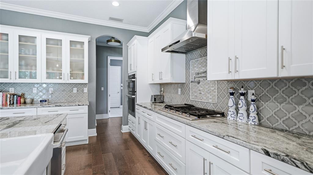4 Flagship Court Palm Coast, FL 32137 - Photo 19 of 64 a kitchen with stainless steel appliances granite countertop a sink stove and cabinets