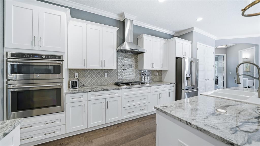 4 Flagship Court Palm Coast, FL 32137 - Photo 21 of 64 a kitchen with stainless steel appliances granite countertop a sink stove and refrigerator