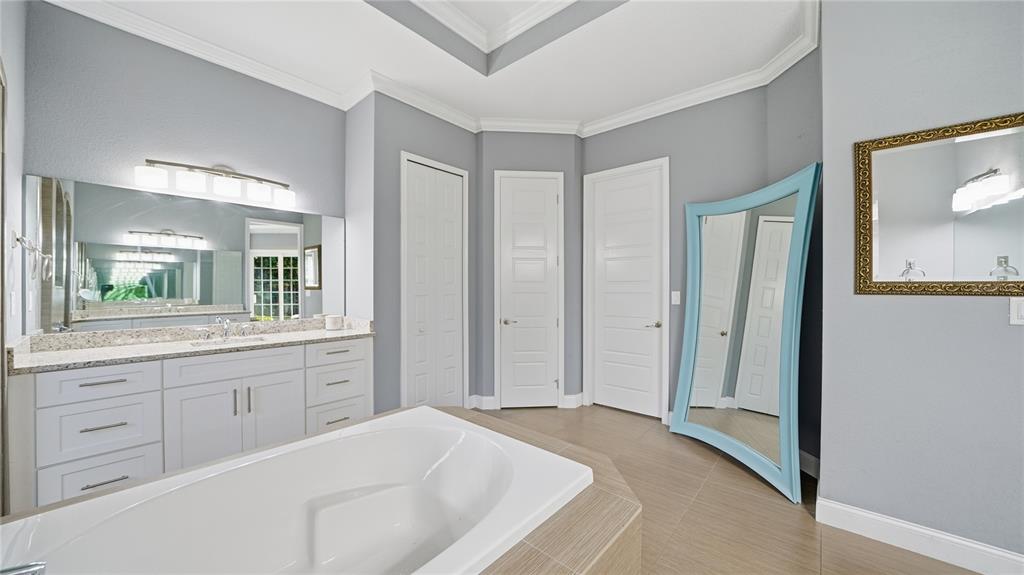 4 Flagship Court Palm Coast, FL 32137 - Photo 27 of 64 a spacious bathroom with a granite countertop sink and a mirror