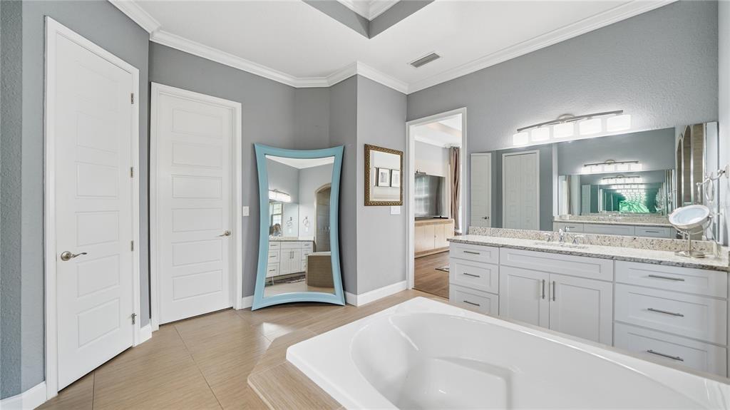 4 Flagship Court Palm Coast, FL 32137 - Photo 28 of 64 a spacious bathroom with a granite countertop sink and a mirror