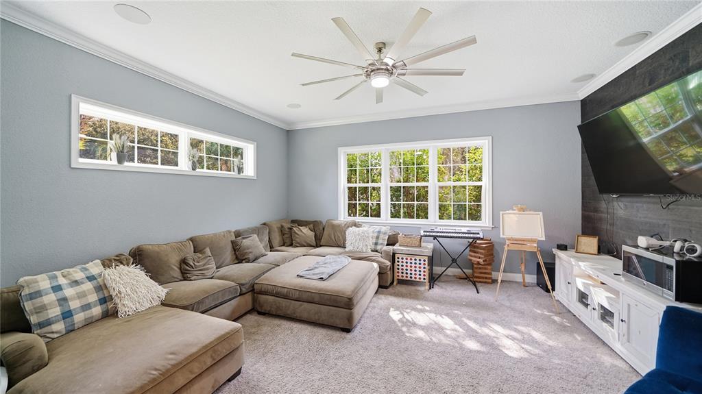 4 Flagship Court Palm Coast, FL 32137 - Photo 30 of 64 a living room with furniture and a flat screen tv