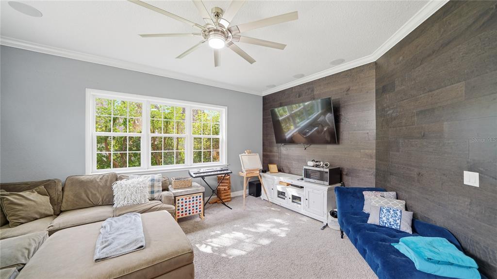 4 Flagship Court Palm Coast, FL 32137 - Photo 31 of 64 a living room with furniture and a flat screen tv