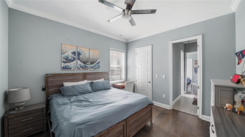 4 Flagship Court Palm Coast, FL 32137 - Photo 42 of 64 a bedroom with a bed and a chandelier