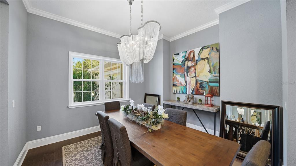 4 Flagship Court Palm Coast, FL 32137 - Photo 10 of 64 a view of a dining room with furniture a chandelier and a window