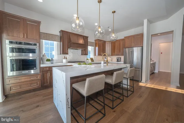a living room with furniture a chandelier and a large window