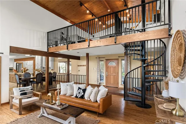 a view of a living room with furniture wooden floor and windows