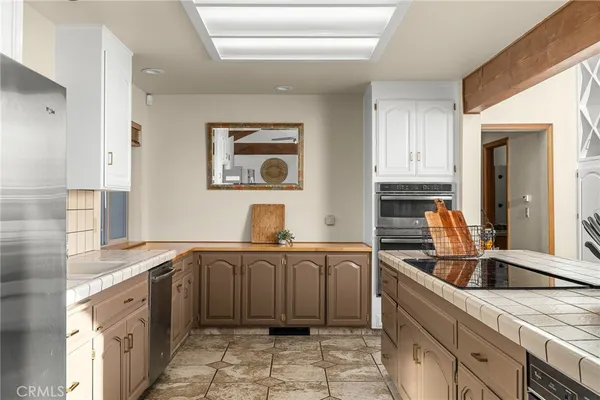 a kitchen with cabinets and stainless steel appliances