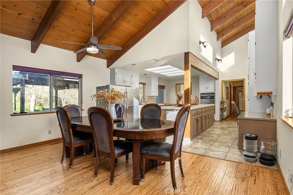 a bedroom with a large bed and a flat tv screen on dresser