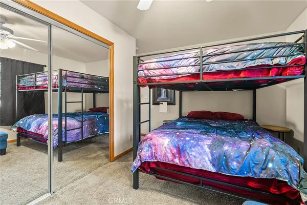 a bathroom with a granite countertop sink mirror vanity and toilet
