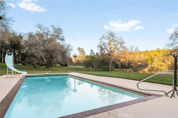 a big yard with trees in front of it