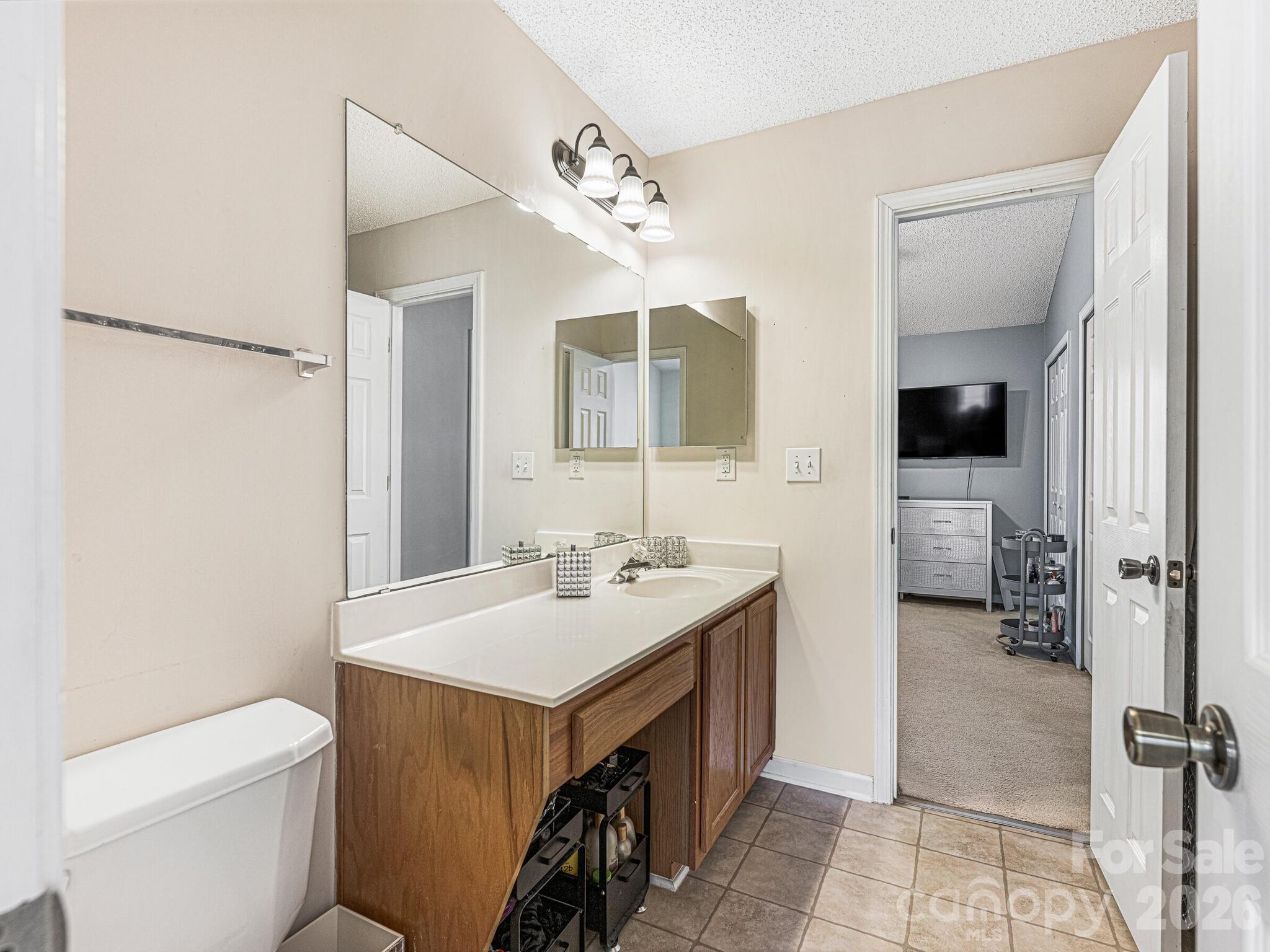 10783 Holly Ridge Boulevard Charlotte, NC 28216 - Photo 14 of 20 a bathroom with a sink a toilet and shower