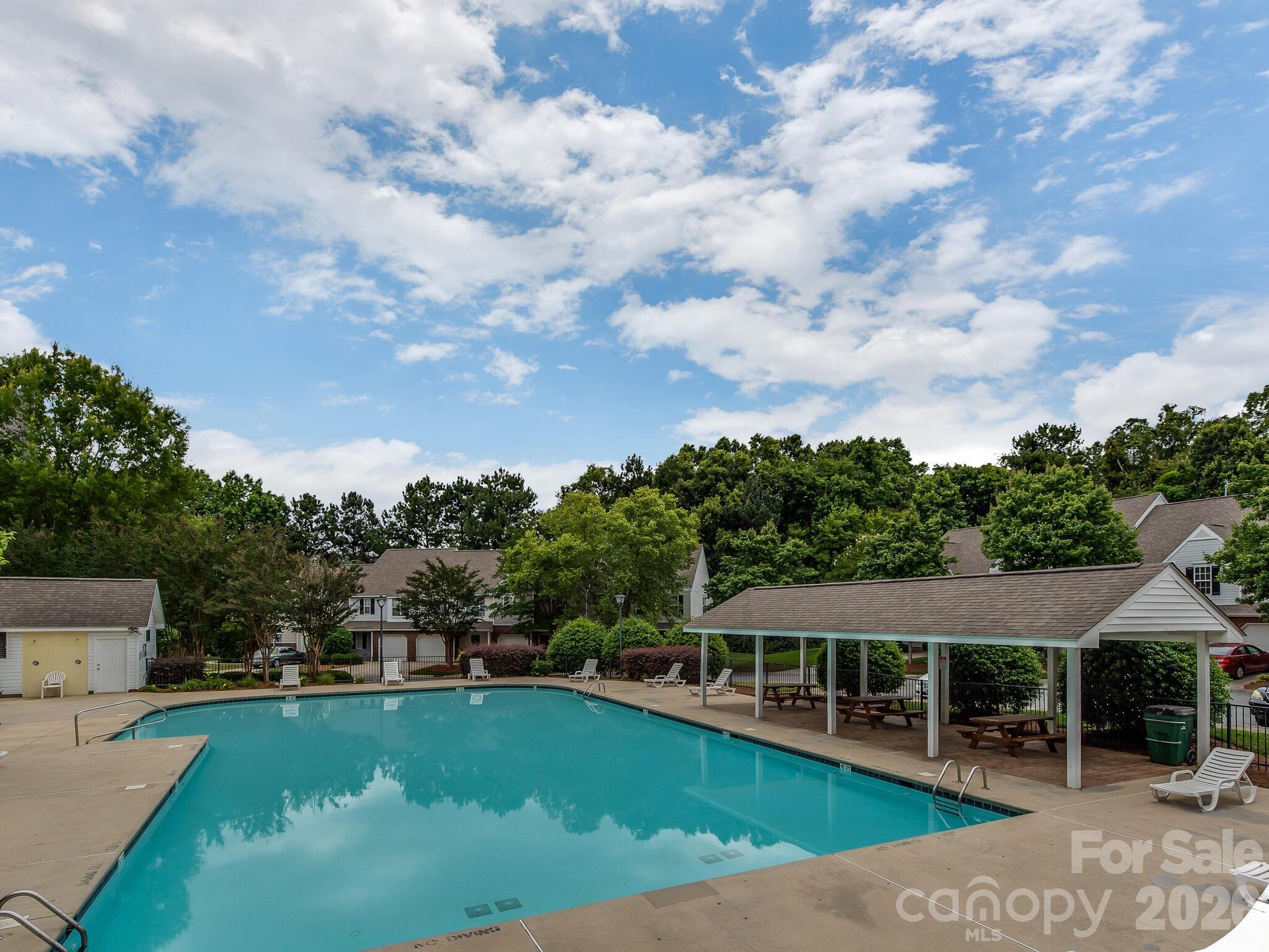 10783 Holly Ridge Boulevard Charlotte, NC 28216 - Photo 20 of 20 an aerial view of a house with swimming pool patio and lake view