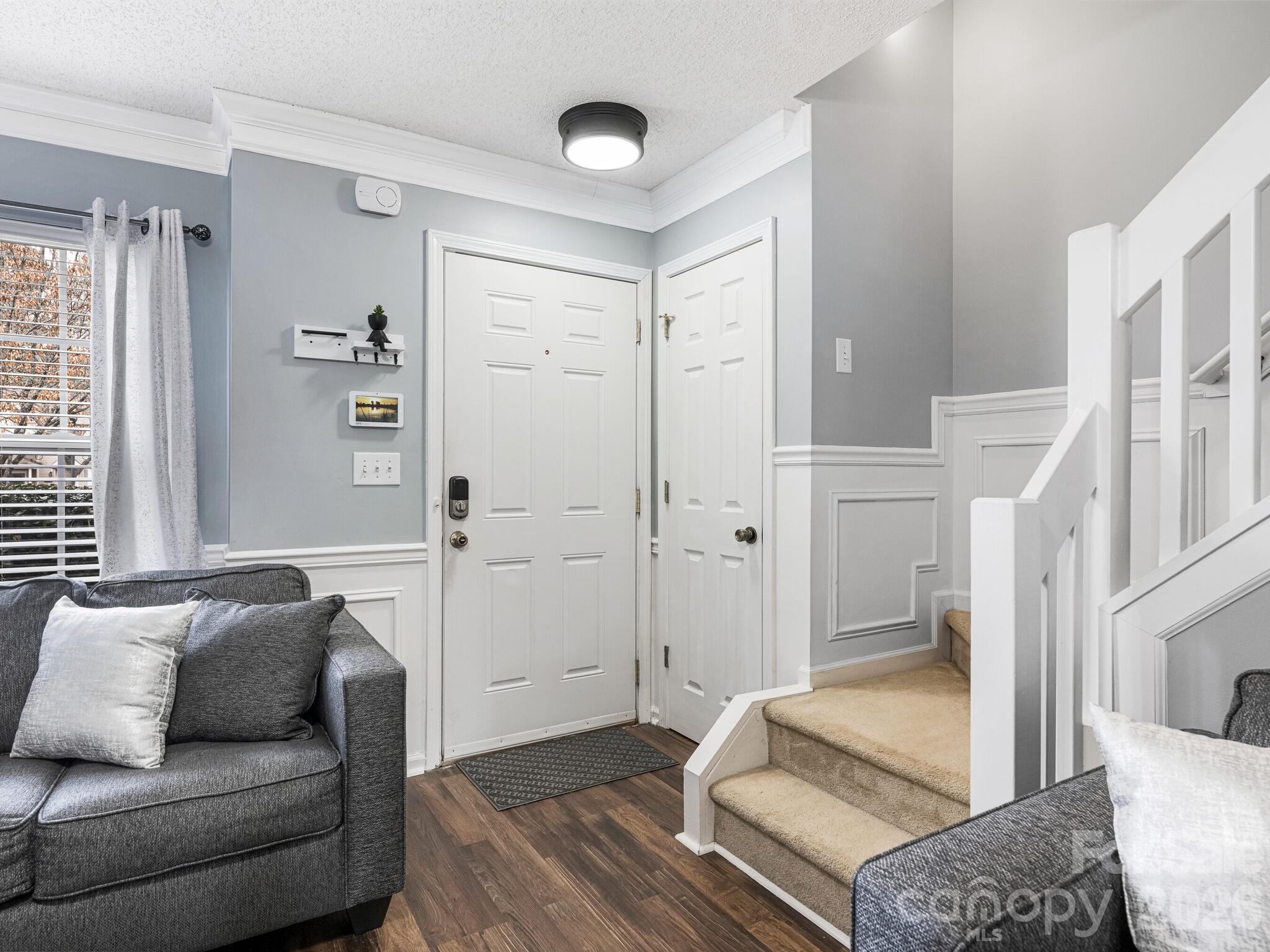 10783 Holly Ridge Boulevard Charlotte, NC 28216 - Photo 3 of 20 a living room with furniture and a rug