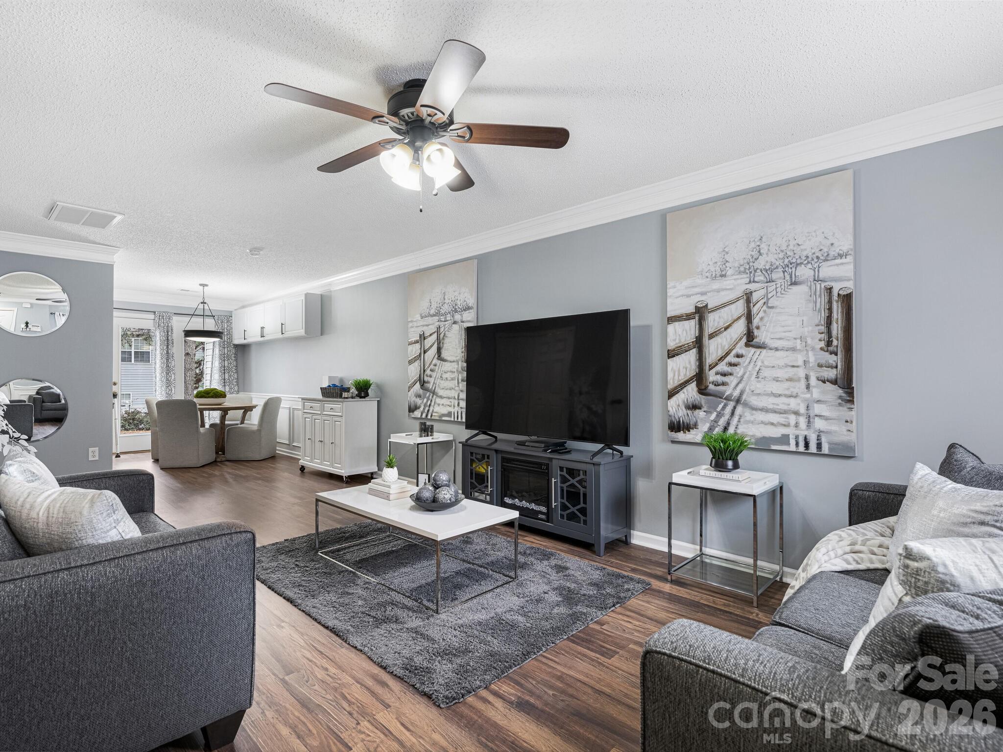 10783 Holly Ridge Boulevard Charlotte, NC 28216 - Photo 4 of 20 a living room with furniture and a flat screen tv