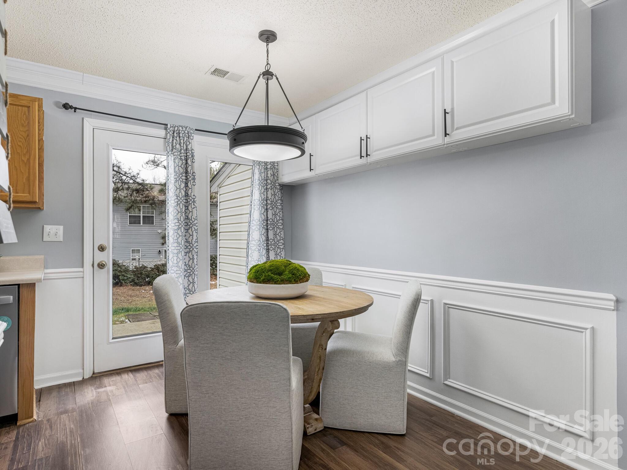 10783 Holly Ridge Boulevard Charlotte, NC 28216 - Photo 7 of 20 a kitchen with a table and chairs
