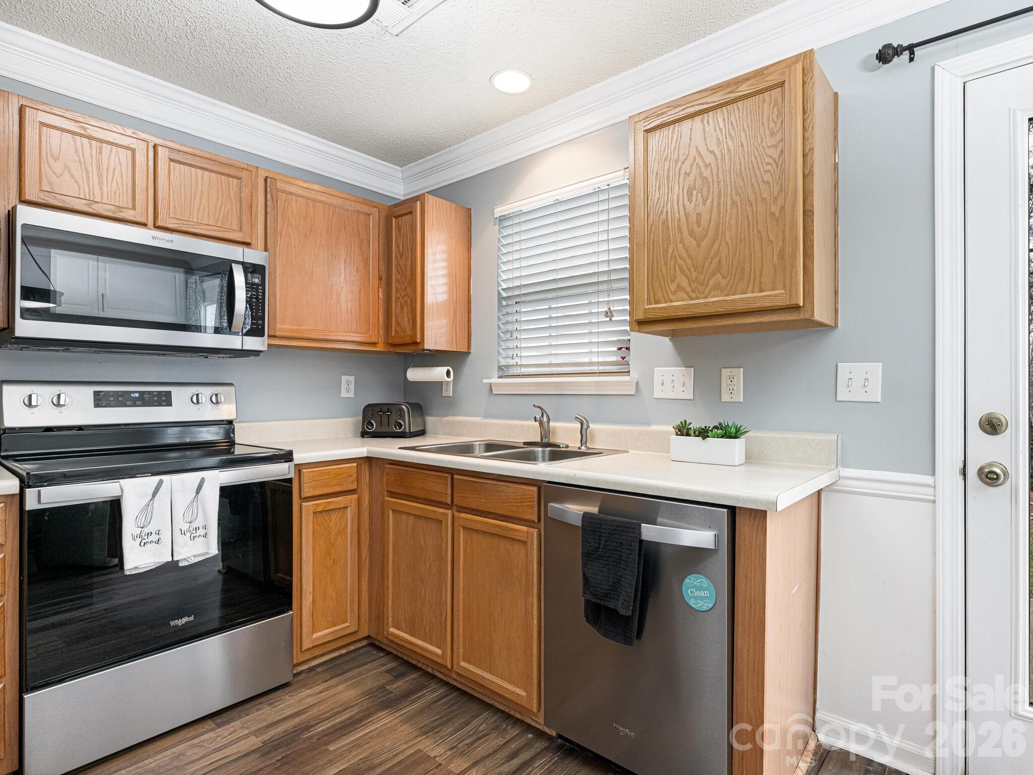 10783 Holly Ridge Boulevard Charlotte, NC 28216 - Photo 10 of 20 a kitchen with a sink stove and microwave