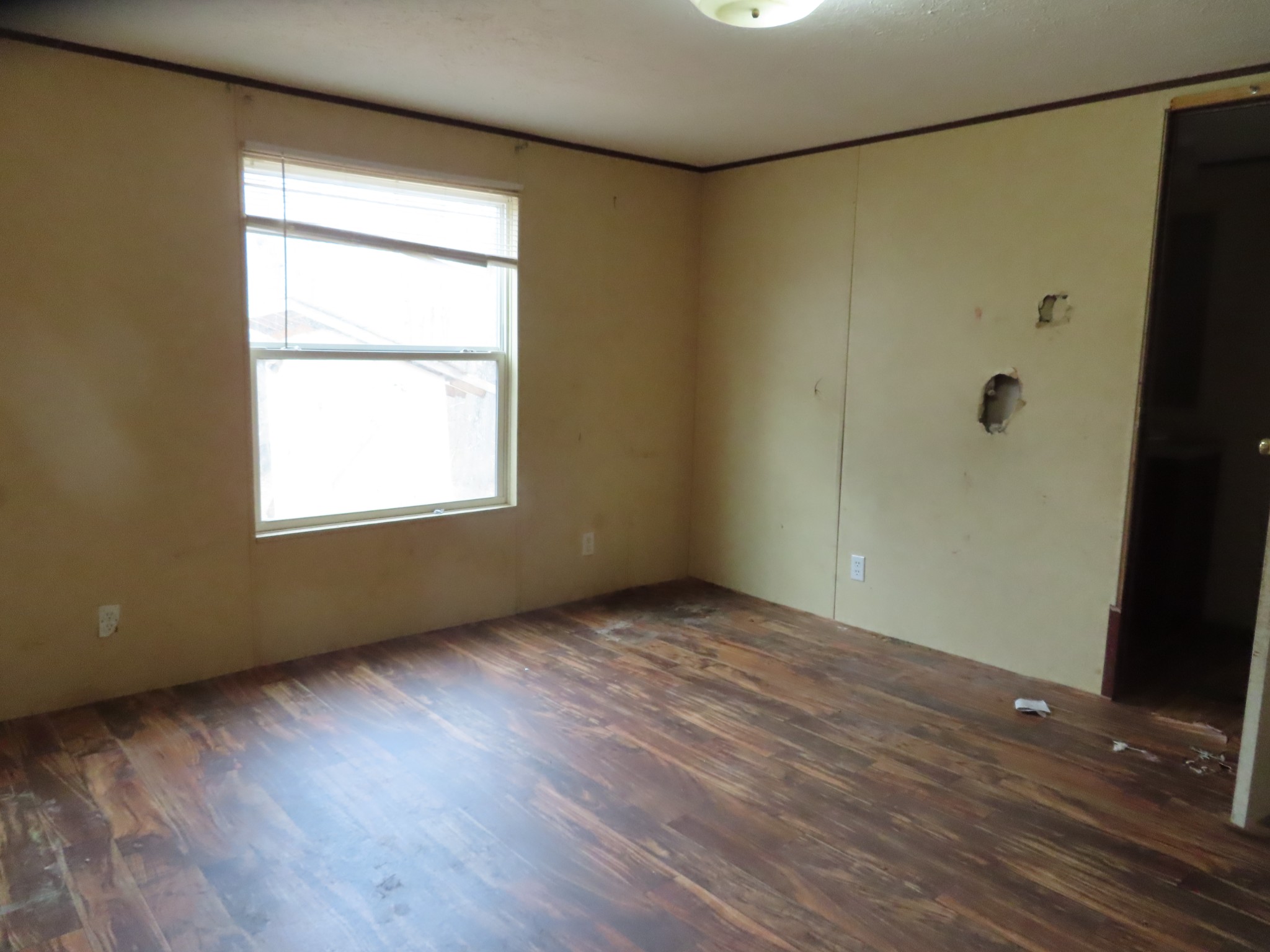 466 Powerline Road Dunlap, TN 37327 - Photo 6 of 9 a view of an empty room with wooden floor and a window