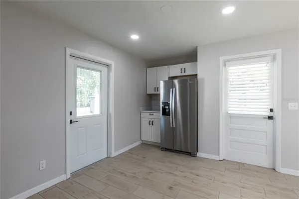an empty room with closet and a window