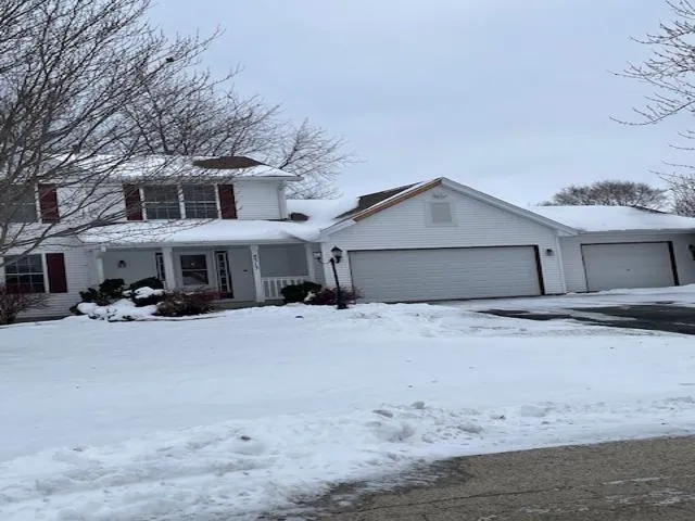 a front view of a house with a yard and a garage