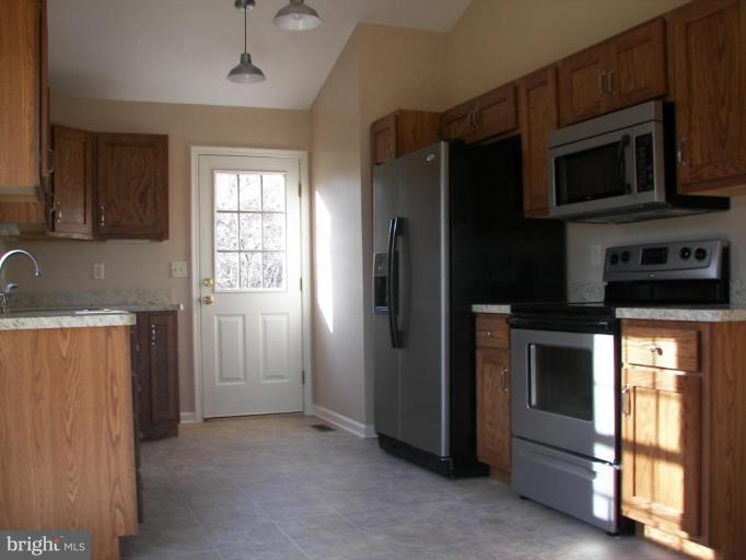 Dimension Court Northeast Inwood, WV 25428 - Photo 2 of 8 a kitchen with stainless steel appliances granite countertop a refrigerator and a stove top oven