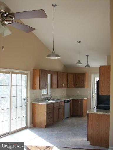 Dimension Court Northeast Inwood, WV 25428 - Photo 3 of 8 a kitchen with stainless steel appliances granite countertop a sink a stove and a refrigerator