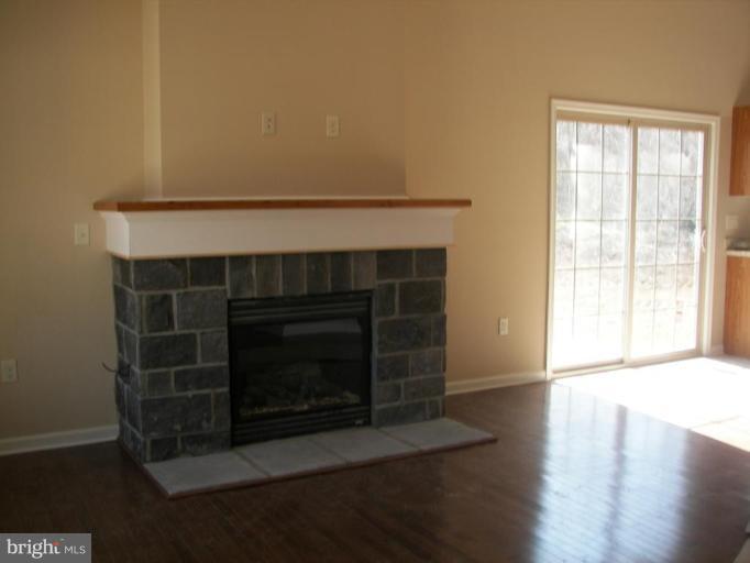 Dimension Court Northeast Inwood, WV 25428 - Photo 8 of 8 a living room with a fireplace