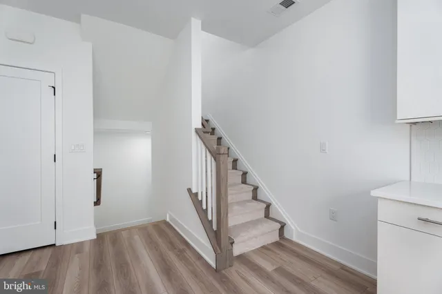 a view of entryway and hall with wooden floor