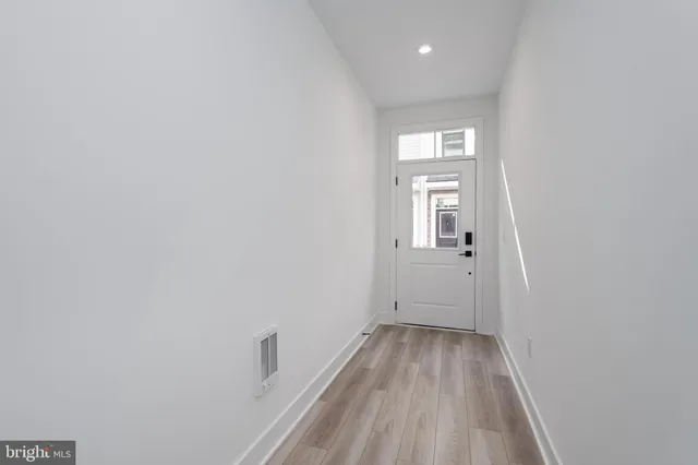 a view of a room with wooden floor and window