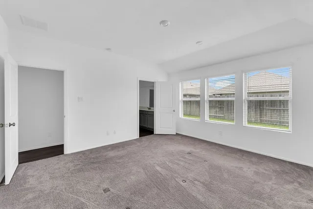 a view of an empty room with a window