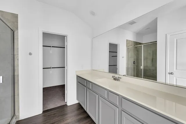 a bathroom with a double vanity sink and mirror