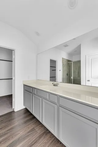 a spacious bathroom with a double vanity sink and a mirror