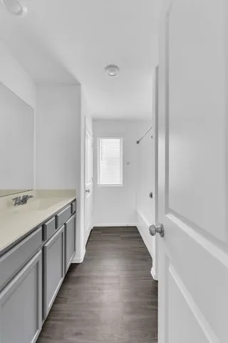 a view of a kitchen with wooden floor and electronic appliances
