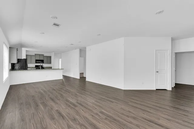 a view of kitchen and hall with wooden floor