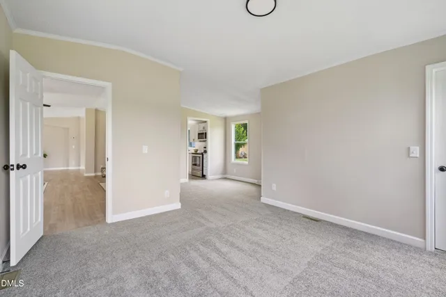 a view of an empty room and closet area